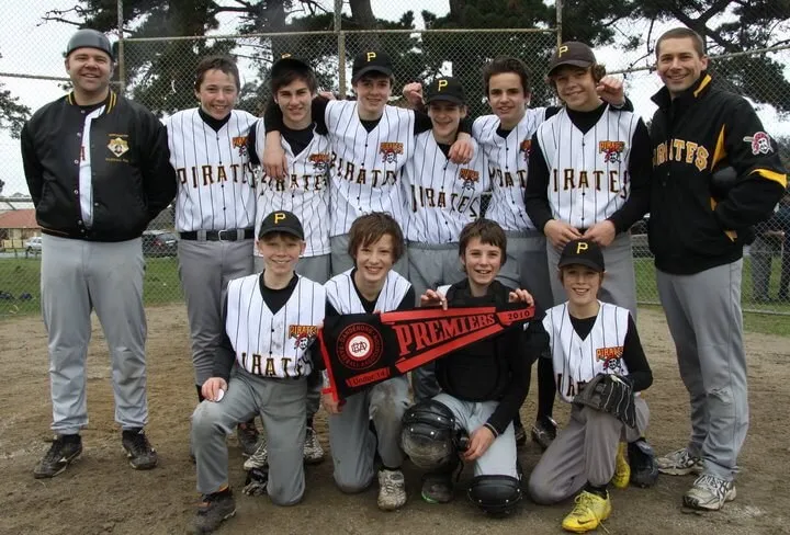A Mornington Pirates junior team with their coaches and a pennant, 2010